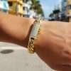 10K Yellow Gold Cuban Link Bracelet 7 Gold bracelet on wrist outdoors