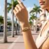 Woman wearing gold bracelet outdoors