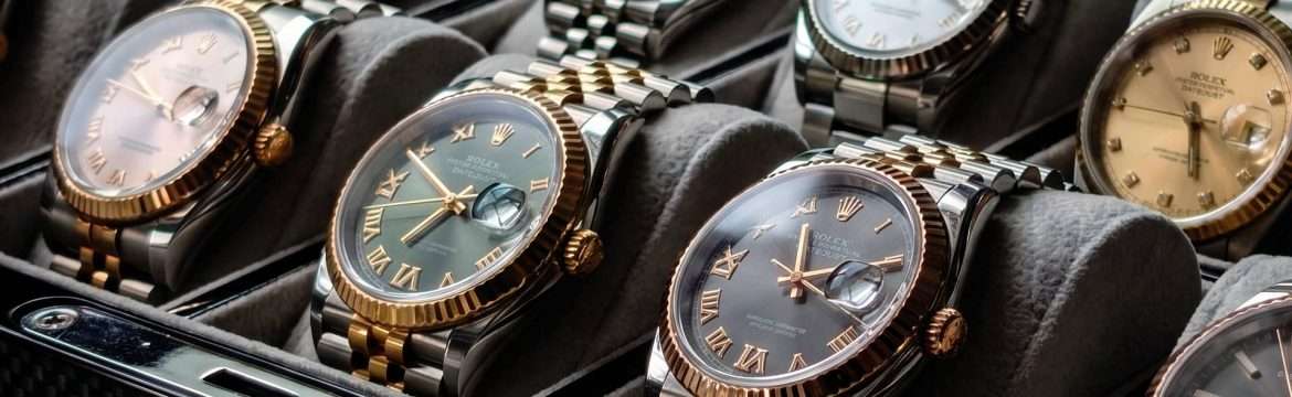 A curated display featuring multiple authentic pre-owned Rolex luxury watches, including Datejust and Submariner models, presented at Grimal Jewelry in Miami