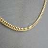 Shiny gold chain on fabric background