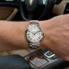 Luxury watch on wrist inside car
