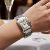 Elegant silver watch on wrist.