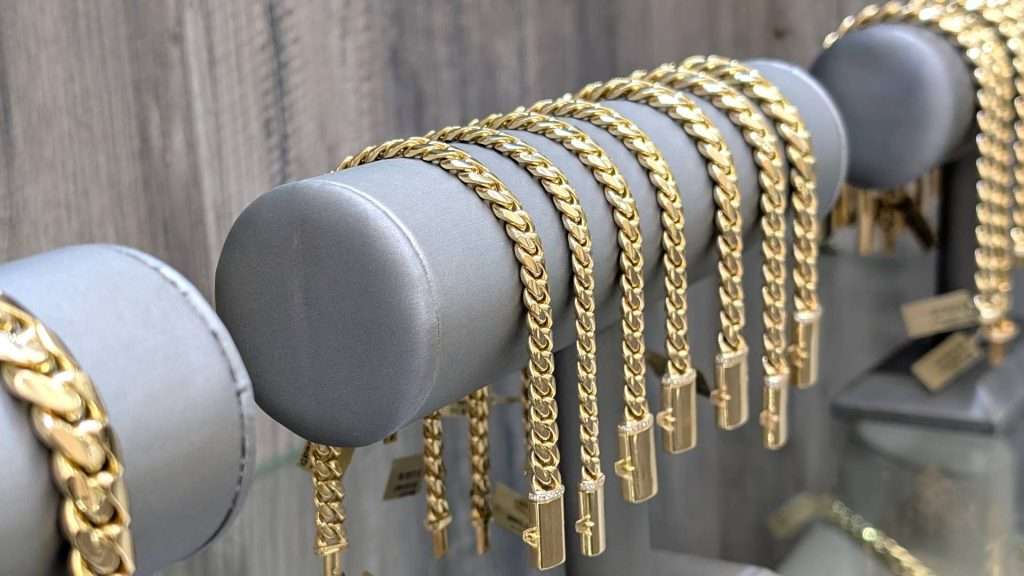 Gold chains displayed on a rack.