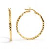 Gold hoop earrings with textured design