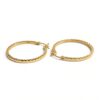Gold hoop earrings with textured design